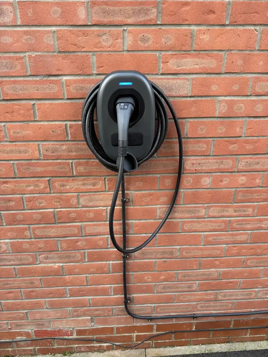 Tethered EV charger installed on a brick house in York