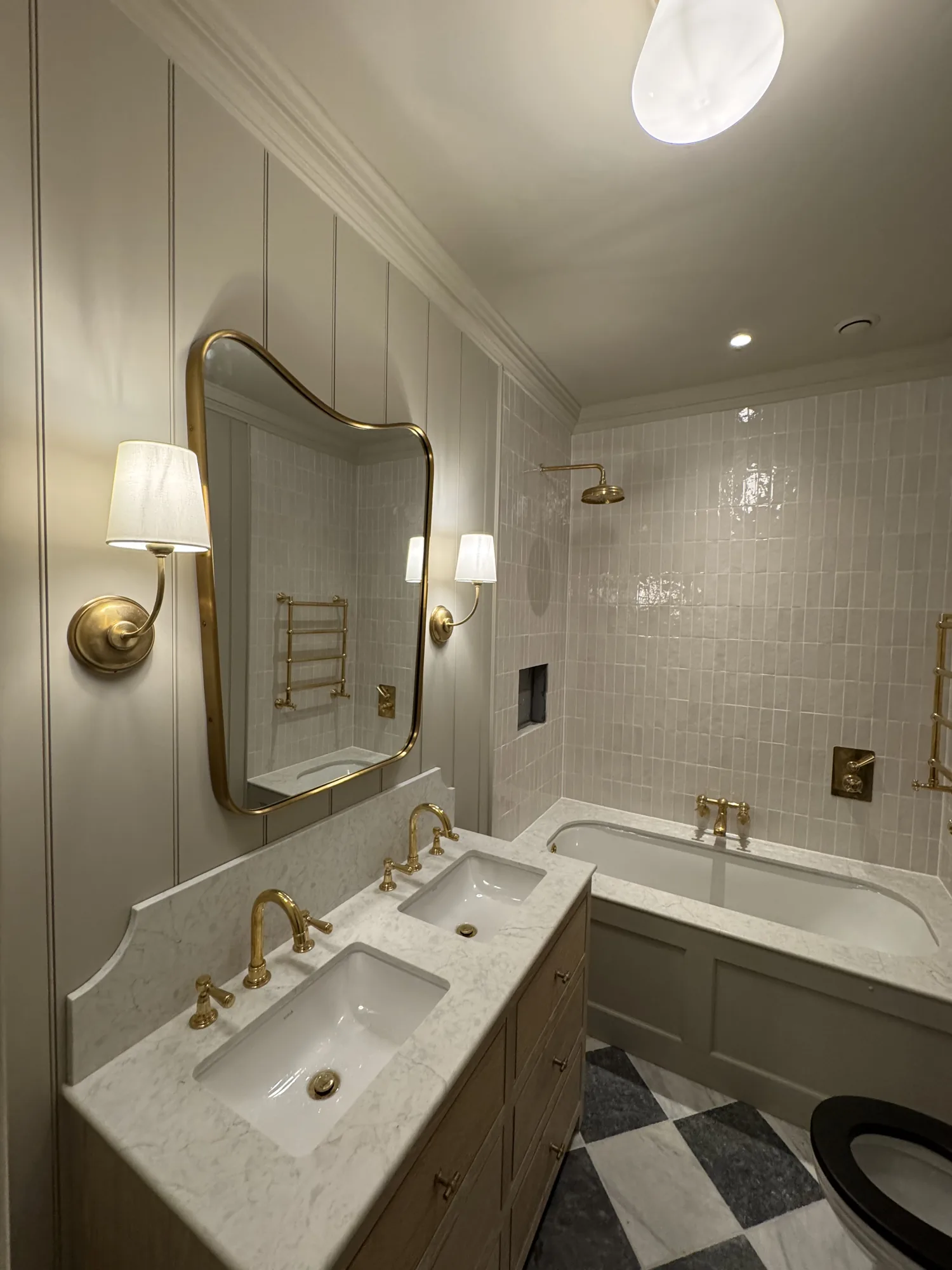 Finished bathroom with wall lights, downlights and heated towel rail