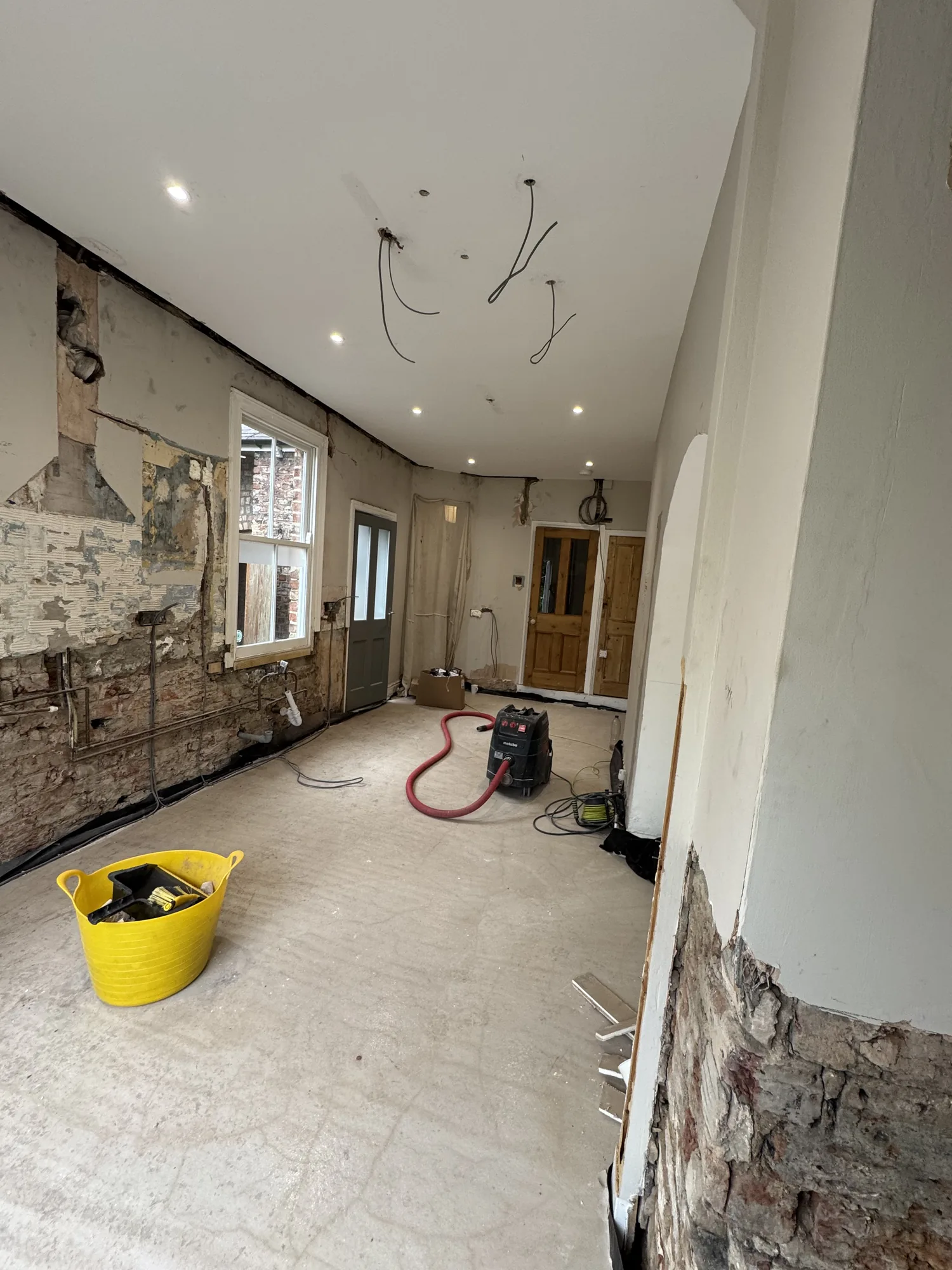 Open-plan room stripped back with new ceiling cables during a rewire