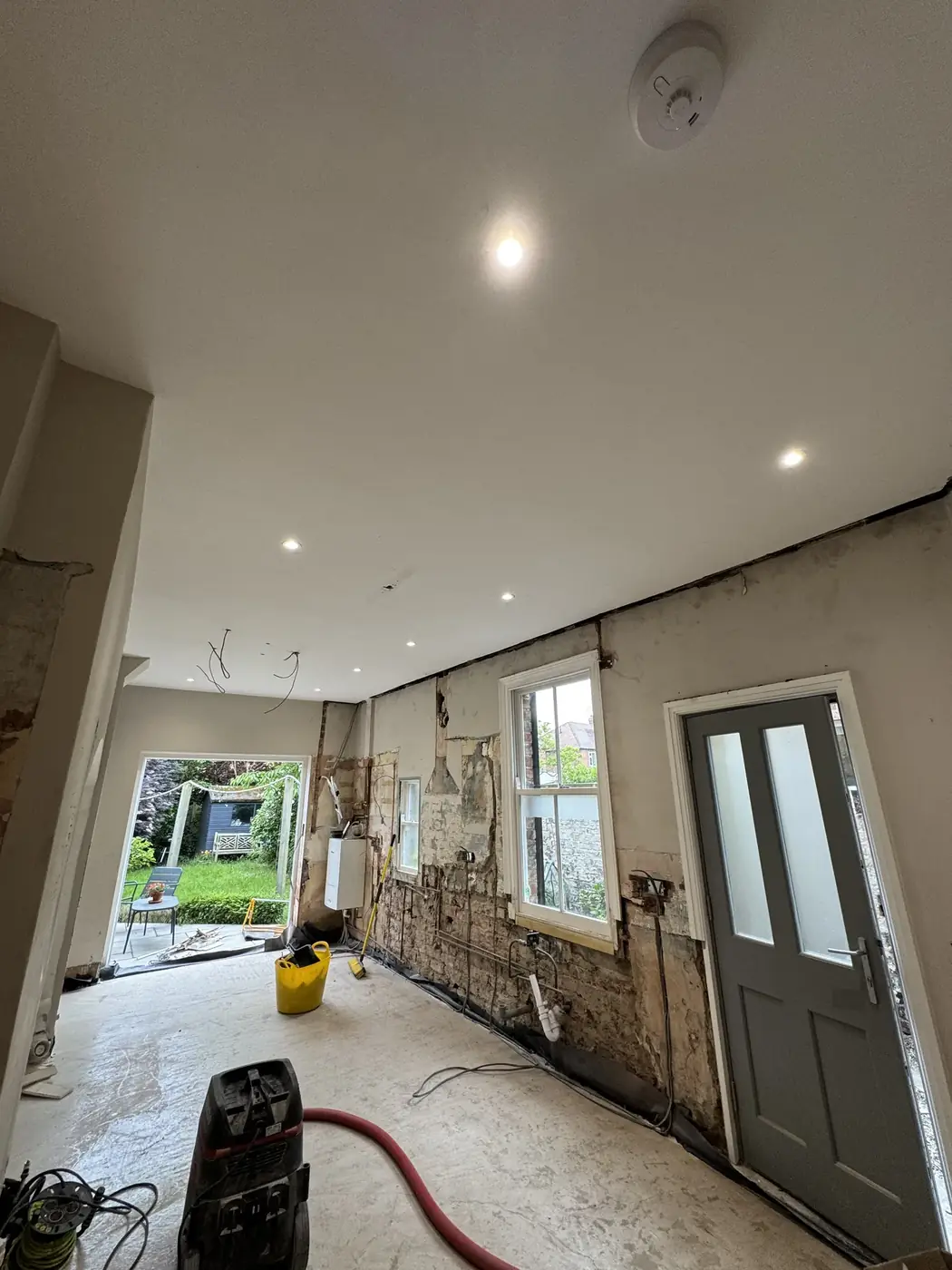 Room after a rewire with new downlights fitted and walls ready for plaster
