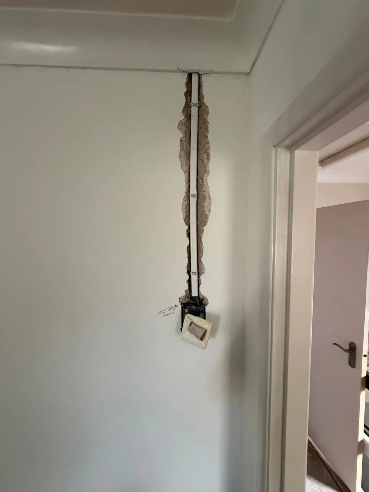 New cable chased into the wall to a switch beside a doorway