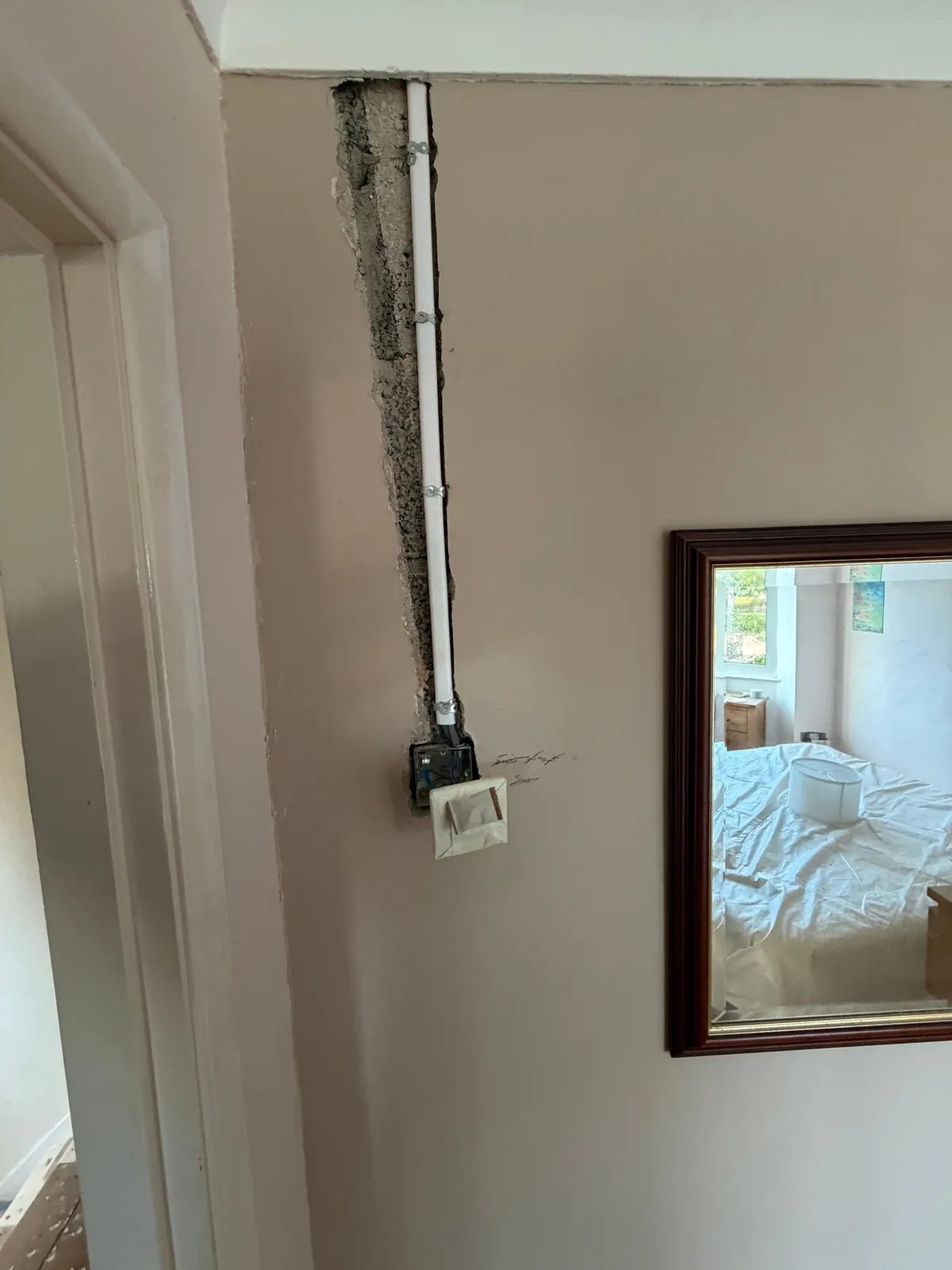 First-fix cable drop to a switch box beside a bedroom door