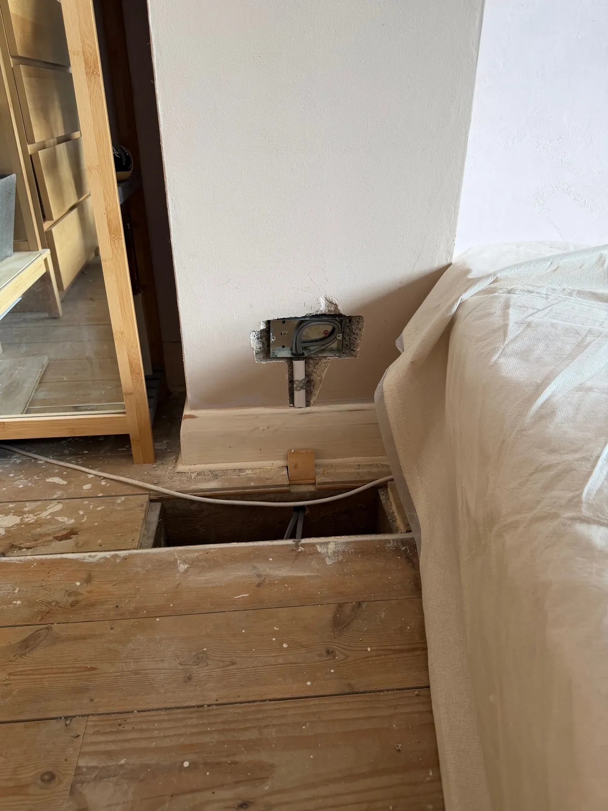 First-fix cable dropped through lifted floorboards to a new socket
